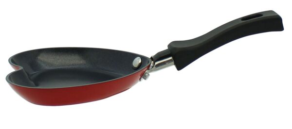 Eine freigestellte, leere, rote Mini-Pfanne in Herzform mit einem langen, schwarzen Griff.